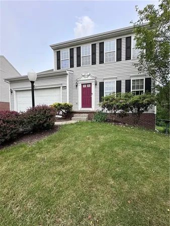 a front view of house with yard and green space