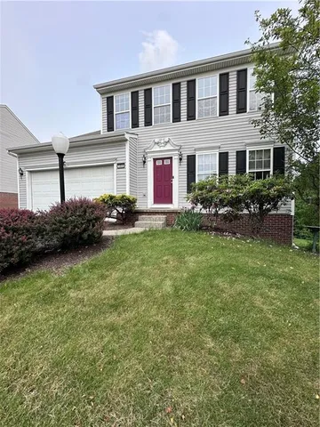 a front view of house with yard and green space