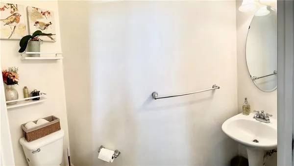 a bathroom with a sink mirror and toilet