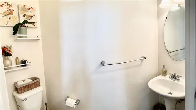 a bathroom with a sink mirror and toilet