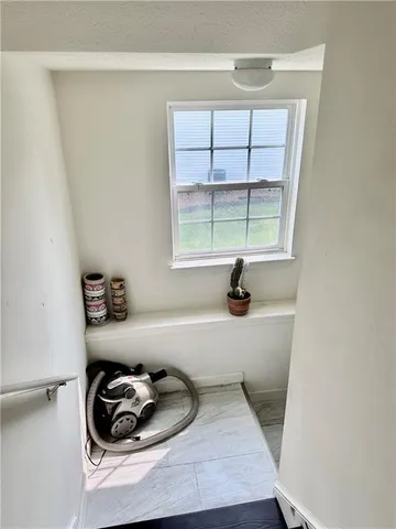 a room with a window and a wooden floor