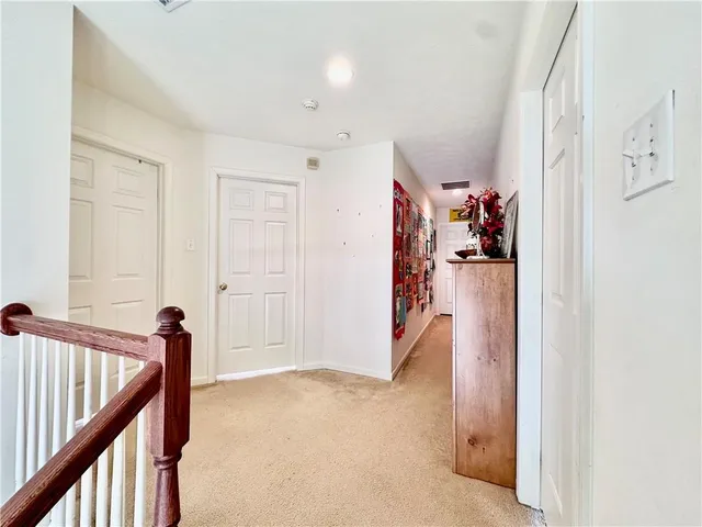 a view of a hallway with closet and utility room