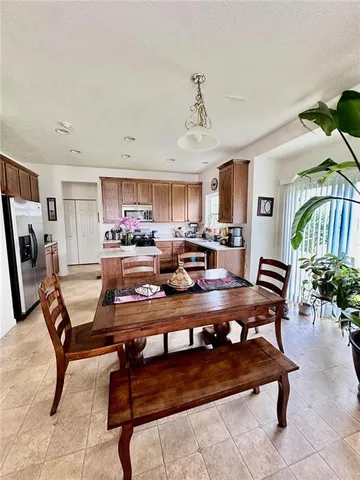 a living room with furniture and a dining table with kitchen view