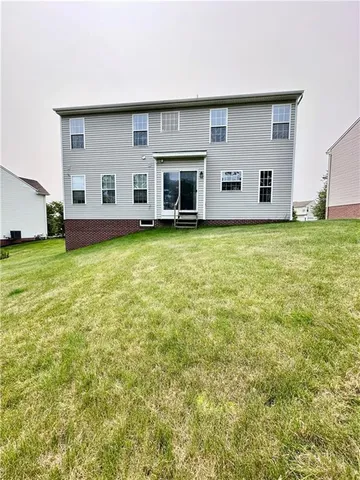 a view of a house with a backyard