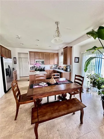 a living room with furniture and a dining table with kitchen view