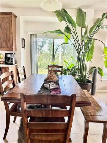 a view of a dining room with furniture and a potted plant