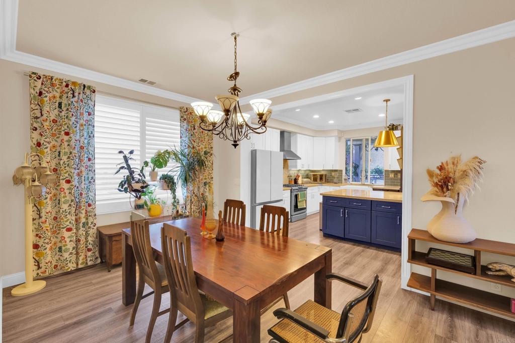 8359 Clover Creek Road Riverside, CA 92508 - Photo 17 of 42 a view of a dining room with furniture window and wooden floor