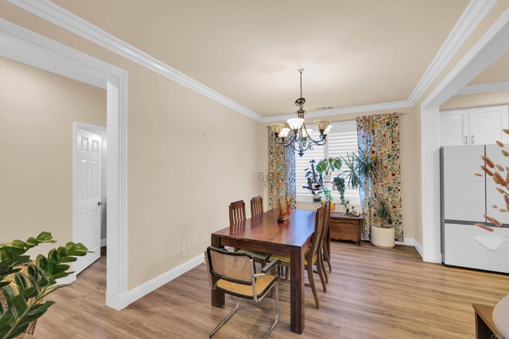 8359 Clover Creek Road Riverside, CA 92508 - Photo 18 of 42 a view of a dining room with furniture window and wooden floor