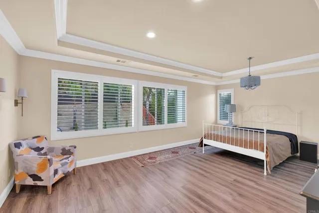 wooden floor in a room with a window and a ceiling fan