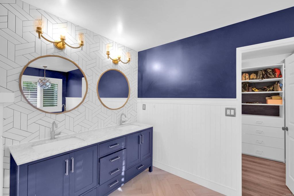 8359 Clover Creek Road Riverside, CA 92508 - Photo 23 of 42 a bathroom with a double vanity sink and a mirror