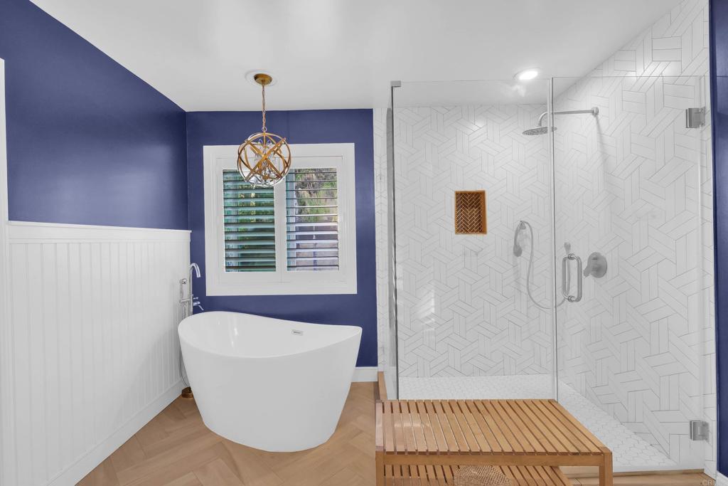 8359 Clover Creek Road Riverside, CA 92508 - Photo 24 of 42 a bathroom with a window a bathtub and shower