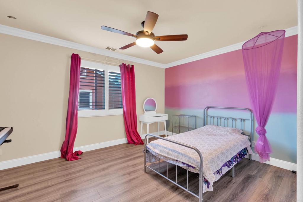 8359 Clover Creek Road Riverside, CA 92508 - Photo 27 of 42 a bedroom with a bed and a chandelier