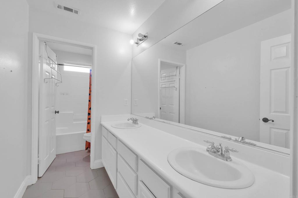 8359 Clover Creek Road Riverside, CA 92508 - Photo 29 of 42 a spacious bathroom with a double vanity sink mirror and double