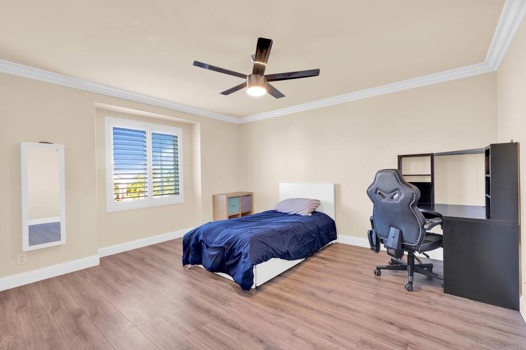 8359 Clover Creek Road Riverside, CA 92508 - Photo 30 of 42 a bedroom with a bed and wooden floor