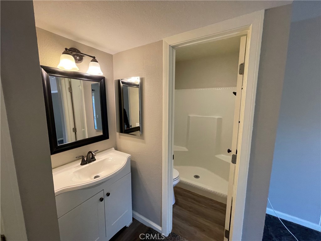 979 West Pine Street Upland, CA 91786 - Photo 11 of 18 a bathroom with a double vanity sink a toilet and shower
