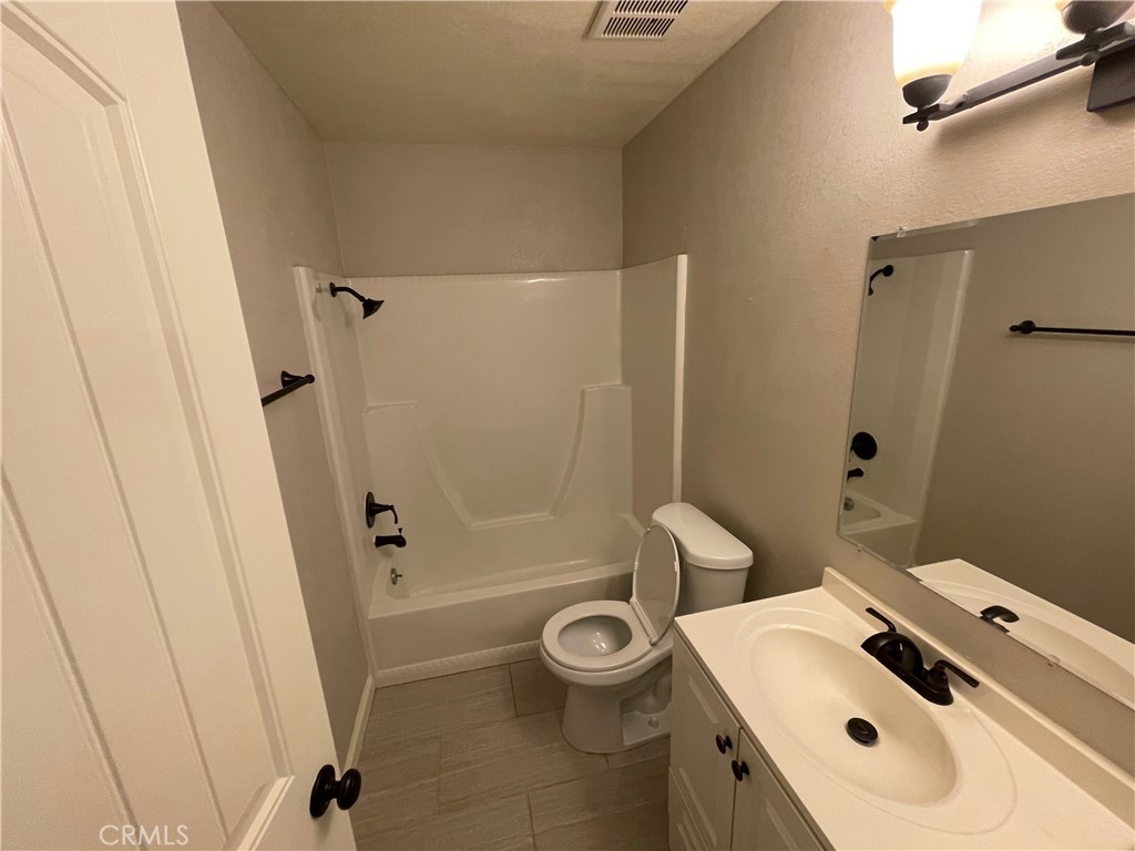 979 West Pine Street Upland, CA 91786 - Photo 12 of 18 a bathroom with a sink a toilet and shower