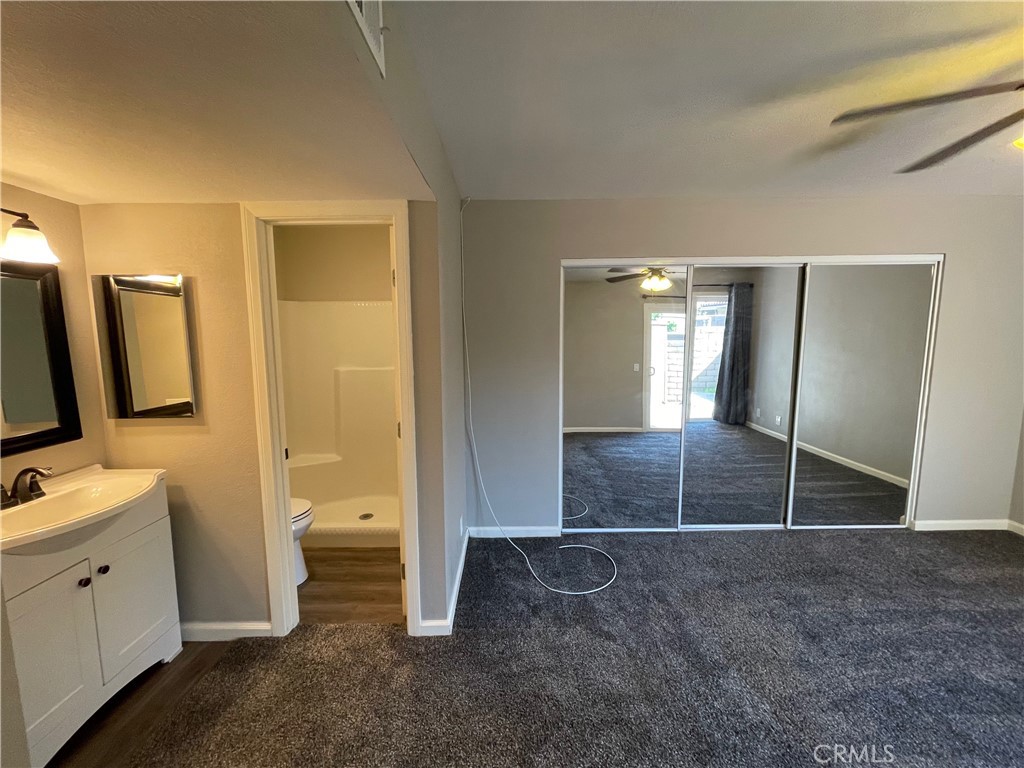 979 West Pine Street Upland, CA 91786 - Photo 9 of 18 a bathroom with a shower a sink a toilet and mirror