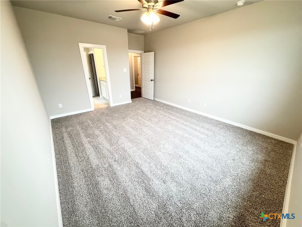 1529 Hillside Drive Temple, TX 76502 - Photo 18 of 19 an empty room with a chandelier fan and closet