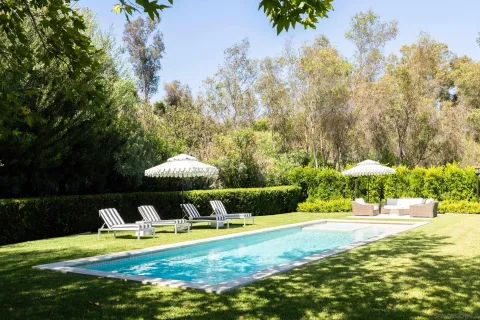 a view of a swimming pool with an outdoor space and seating area