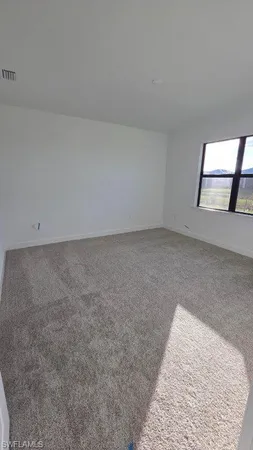 an empty room with a rug