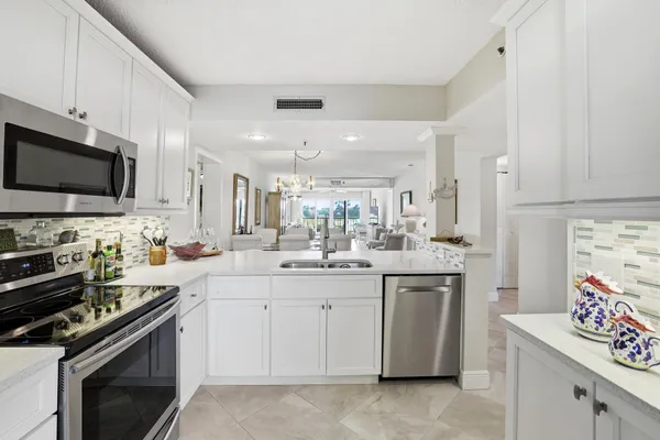 a kitchen with a refrigerator stove and microwave