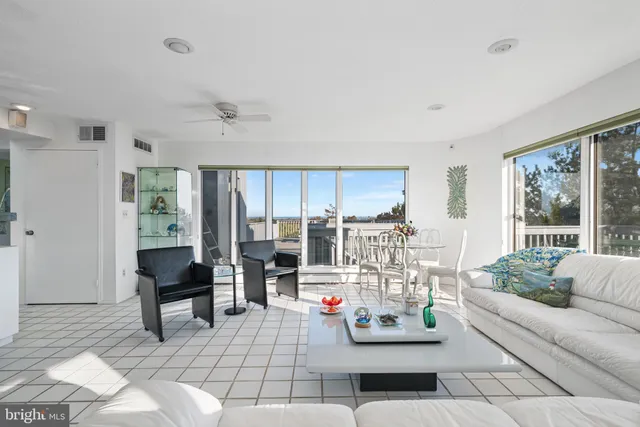a living room with furniture and a floor to ceiling window