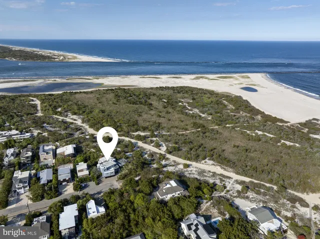 a bedroom with two beds and a chandelier