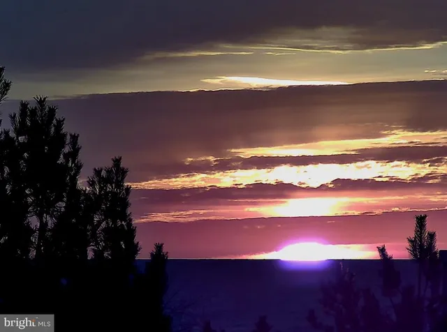 a large living room with a large window and dining table
