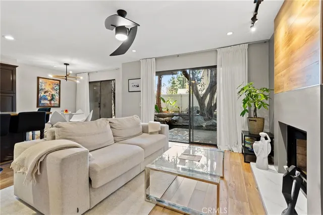 a living room with furniture fireplace and a large window