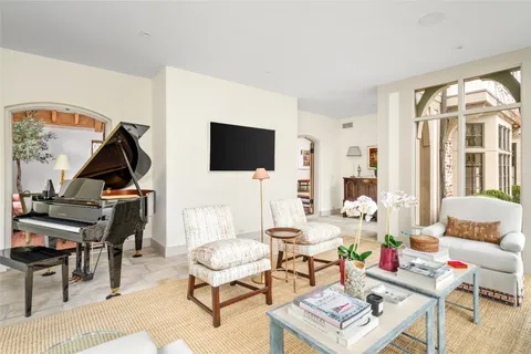 a living room with furniture a rug and a flat screen tv