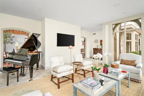 a living room with furniture a rug and a flat screen tv
