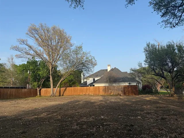 a view of a road with a house in the background