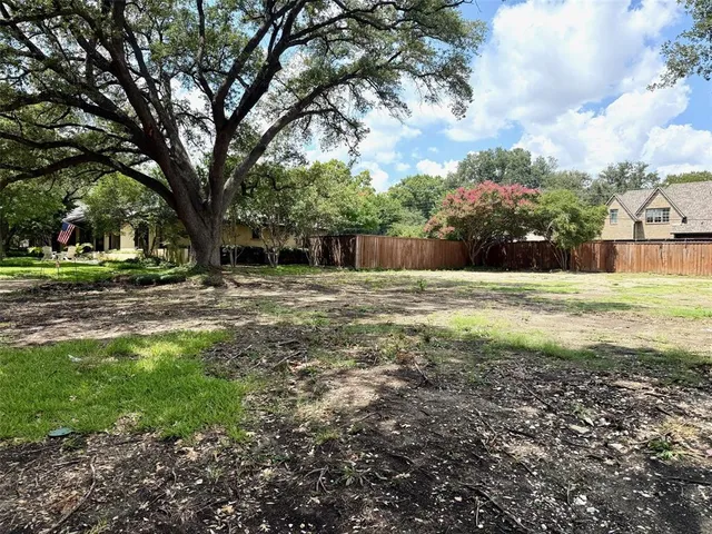a view of swimming pool with a tree in the background