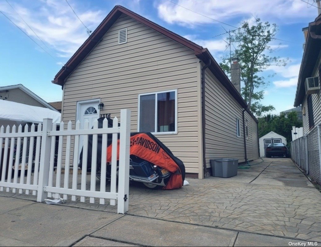 a view of a house with a yard and deck
