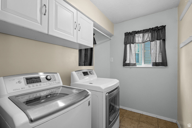 142 East 2675th Street South Clearfield, UT 84015 - Photo 17 of 49 Laundry area featuring upper cabinetry, a window, and tile flooring