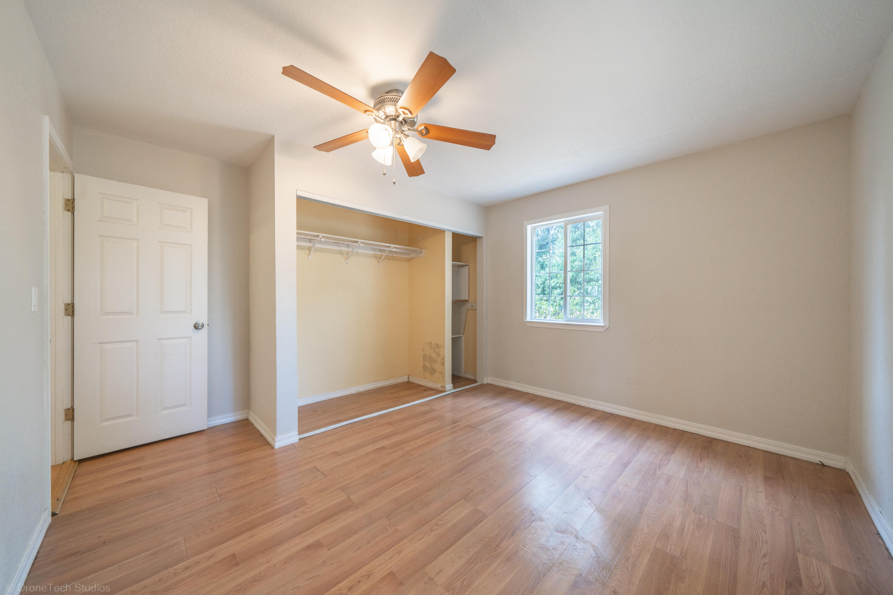 7673 Happy Valley Road Anderson, CA 96007 - Photo 21 of 72 a view of an empty room with wooden floor and a window