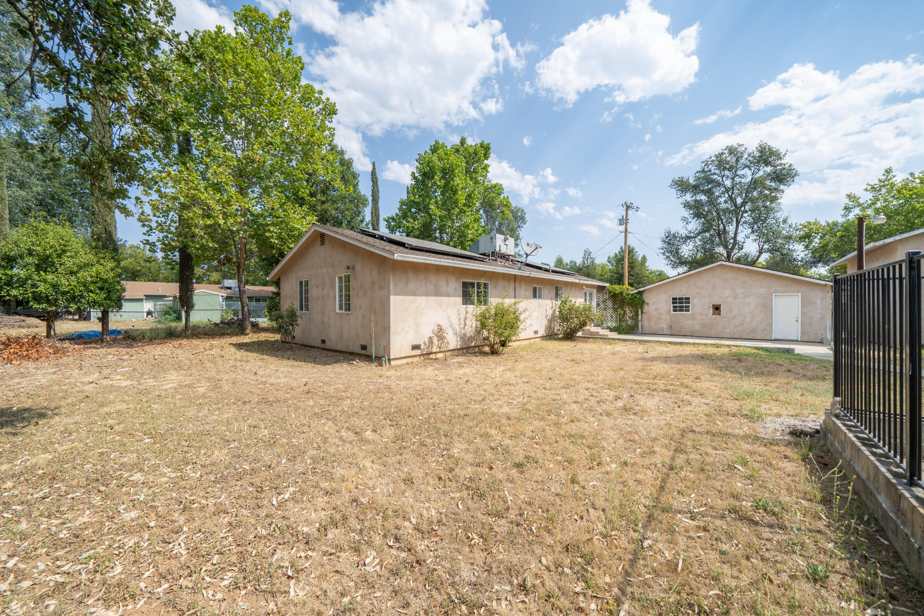 7673 Happy Valley Road Anderson, CA 96007 - Photo 46 of 72 a view of a house with backyard and a tree