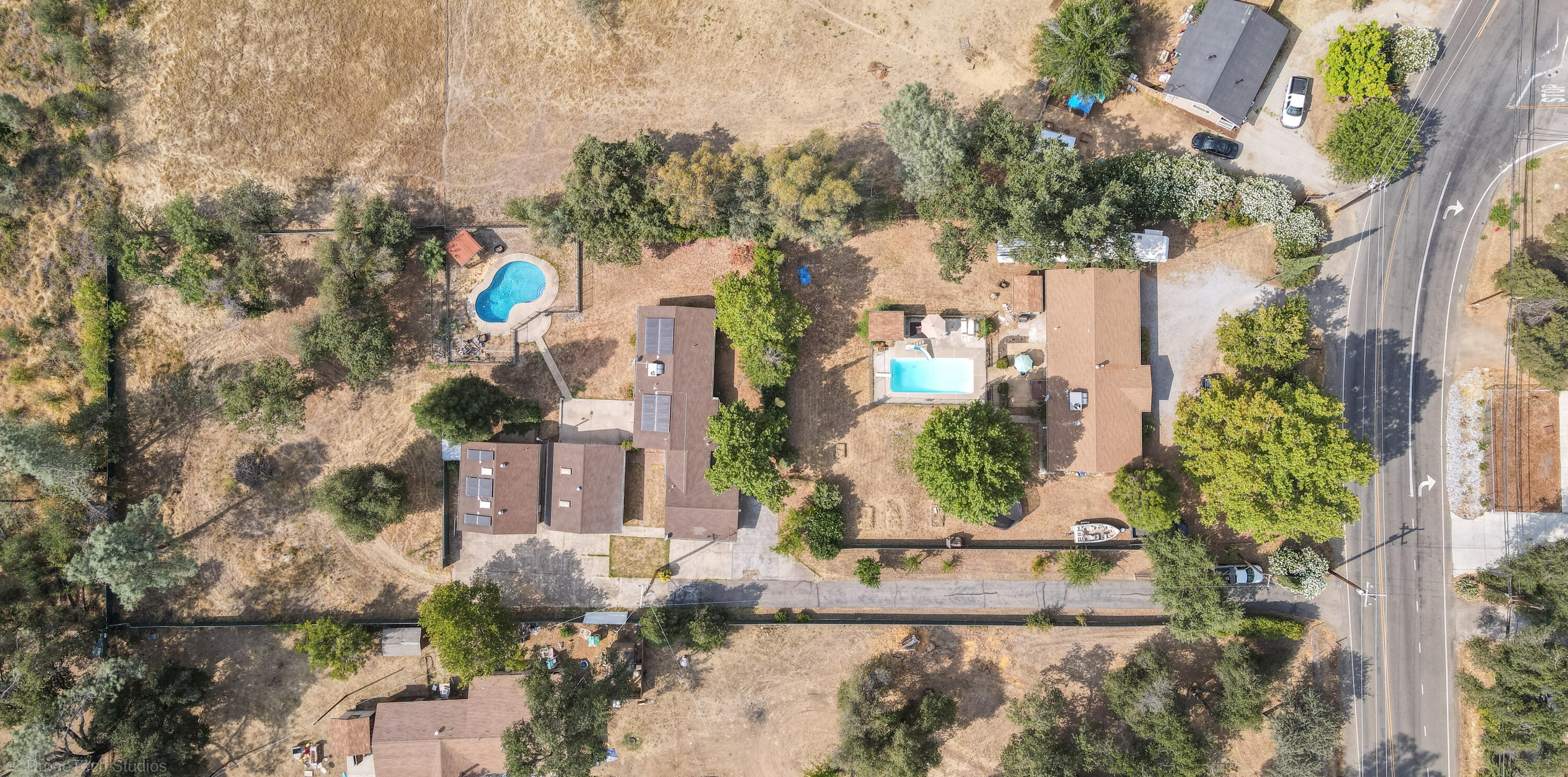 7673 Happy Valley Road Anderson, CA 96007 - Photo 72 of 72 an aerial view of a house with a yard and large trees