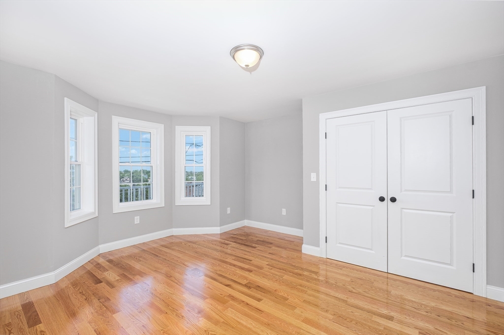 216 Vane Street, Unit 2 Revere, MA 02151 - Photo 12 of 22 a view of empty room with wooden floor and fan