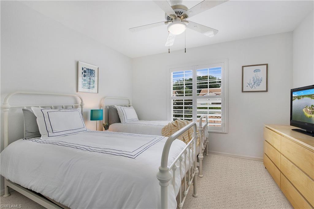8375 Excalibur Circle, Unit I4 Naples, FL 34108 - Photo 12 of 17 a bed room with a bed a television and a window