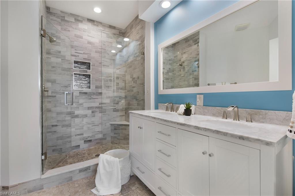 8375 Excalibur Circle, Unit I4 Naples, FL 34108 - Photo 13 of 17 a bathroom with a sink a toilet and shower