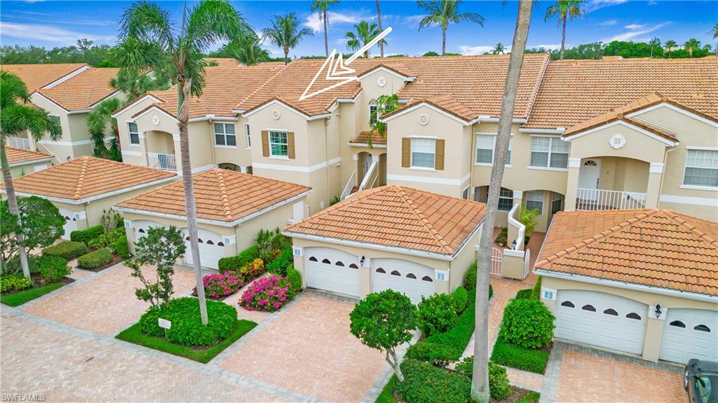 8375 Excalibur Circle, Unit I4 Naples, FL 34108 - Photo 15 of 17 a view of a white house with a yard and potted plants