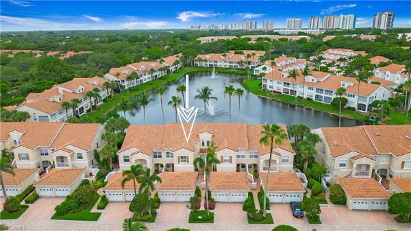 an aerial view of residential houses with outdoor space and lake view