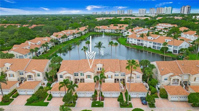 an aerial view of residential houses with outdoor space and lake view