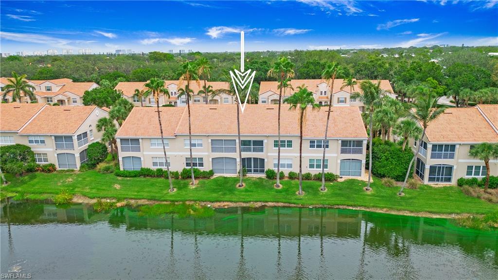 8375 Excalibur Circle, Unit I4 Naples, FL 34108 - Photo 17 of 17 a view of a house with a big yard and large trees