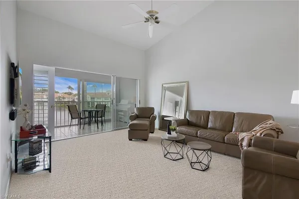 a living room with furniture and a floor to ceiling window
