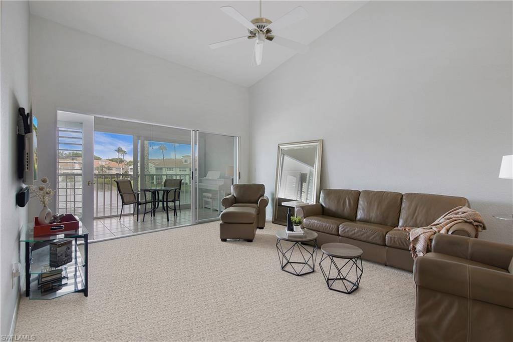 8375 Excalibur Circle, Unit I4 Naples, FL 34108 - Photo 4 of 17 a living room with furniture and a floor to ceiling window