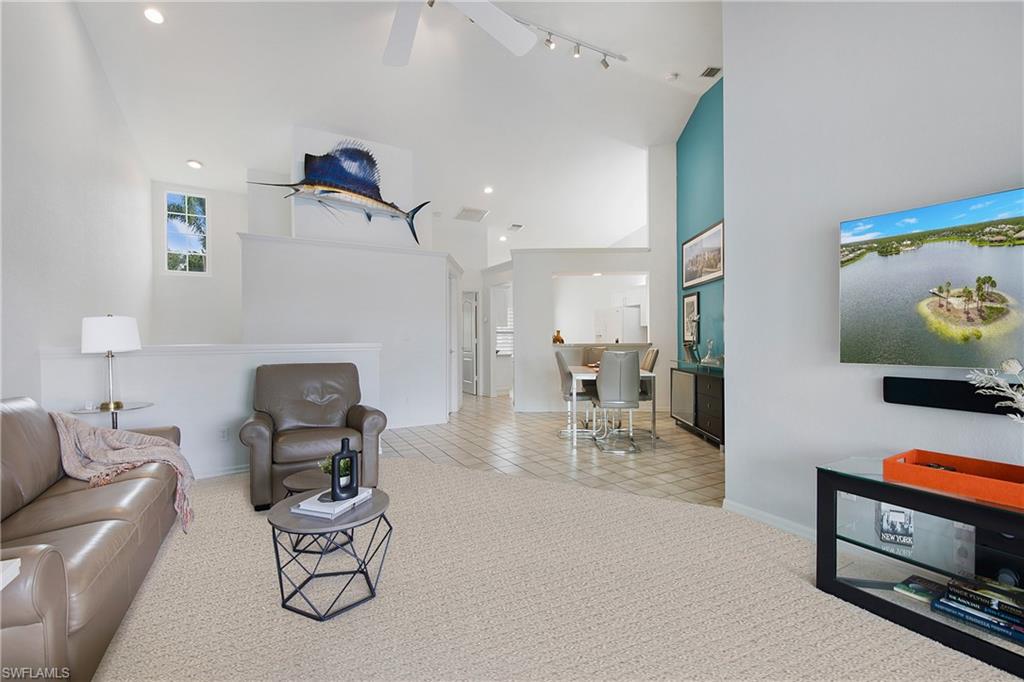 8375 Excalibur Circle, Unit I4 Naples, FL 34108 - Photo 5 of 17 a living room with furniture and kitchen view