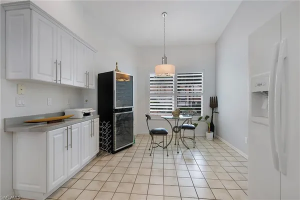a kitchen with granite countertop a sink cabinets and window