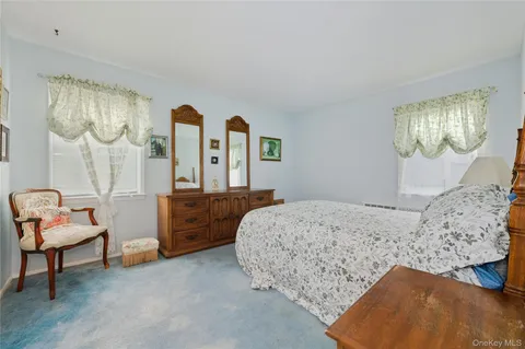 a bedroom with a bed and a dresser in it